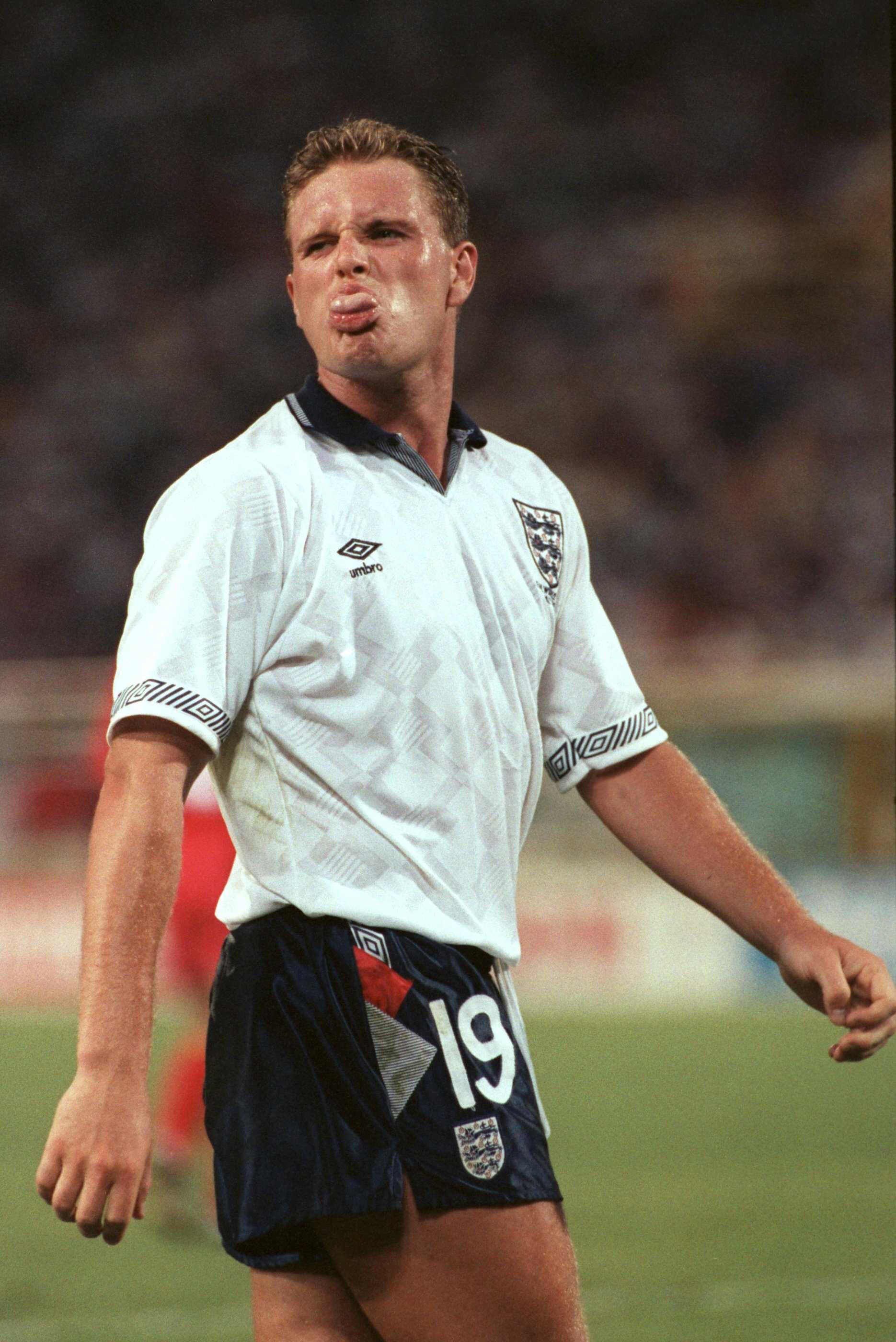 England's Paul Gascoigne sticks his tongue out at a group of photographers